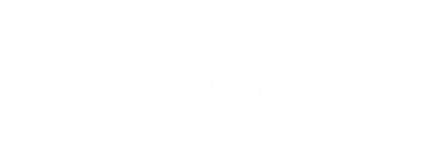Alpenglow Vacation Rentals logo, featuring a stylized purple and red script font alongside an outline of mountain peaks
